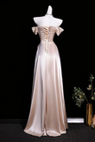 Beige evening gown on a mannequin against a black background