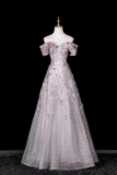 Elegant silver evening gown on a mannequin against a black background