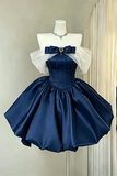 Navy blue and white dress on a mannequin against a neutral background