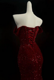 Red sequin dress on a mannequin against a black background