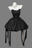 Black dress on a mannequin with a gray background