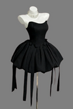 Black dress on a mannequin with a gray background