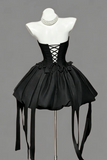 Black corset-style dress on a mannequin against a gray background