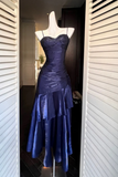 Blue evening gown on a mannequin against a neutral background