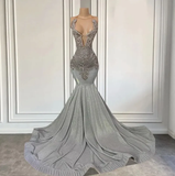 Silver evening gown with intricate beading on a mannequin against a neutral background