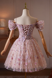 Pink floral dress on a mannequin against a neutral background