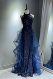 Navy blue sequin evening gown on a mannequin against a neutral background
