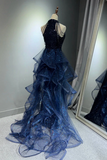 Navy blue evening gown on a mannequin with a mirror reflection.