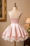 Pink satin dress on a mannequin against a neutral wall with a lamp and framed picture.