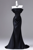 Black evening gown on a mannequin against a gray background