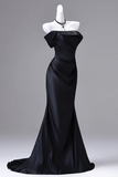 Black evening gown on a mannequin against a gray background