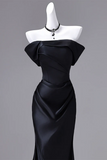 Black strapless gown on a mannequin against a gray background