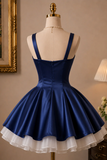 Navy blue dress with white underskirt on a mannequin against a neutral wall.