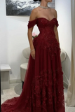 Red evening gown with beaded details worn by a person, in an indoor setting.