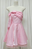 Pink dress with a bow on a mannequin against a white background