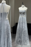 Silver sequin evening gown with a sheer overlay on a mannequin against a neutral background.