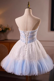 White and blue dress on a mannequin against a neutral background