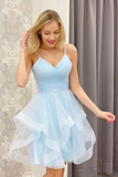 Woman wearing a light blue dress against a neutral background