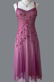 A sleeveless midi dress in dusty mauve pink tulle with floral bead and sequin embellishments, displayed on a white mannequin torso against a solid gray background.