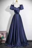 A navy blue A-line formal gown with puff sleeves and a sweetheart neckline, displayed on a mannequin against a plain white wall.