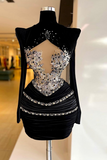 Black dress with silver embellishments on a mannequin against a blurred indoor background