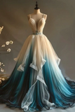 Elegant gown with gradient color from beige to blue on a mannequin against a neutral background.