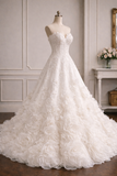 An ivory white strapless A-line wedding gown with 3D floral rosette layers on the skirt, displayed on a mannequin in a classic indoor room setting.